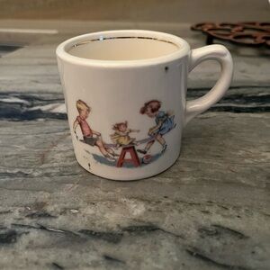 Antique Children's Mug with Playful Design